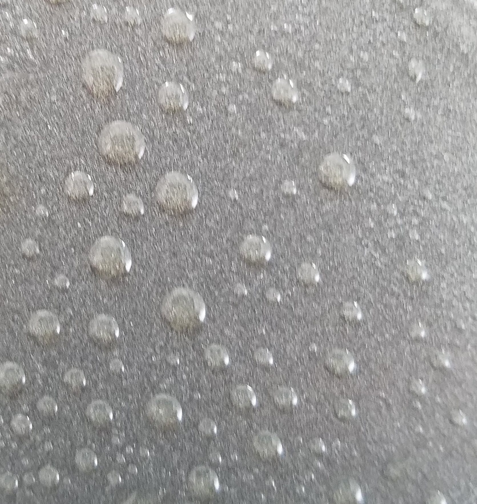 A photograph of raindrops on a piece of glass